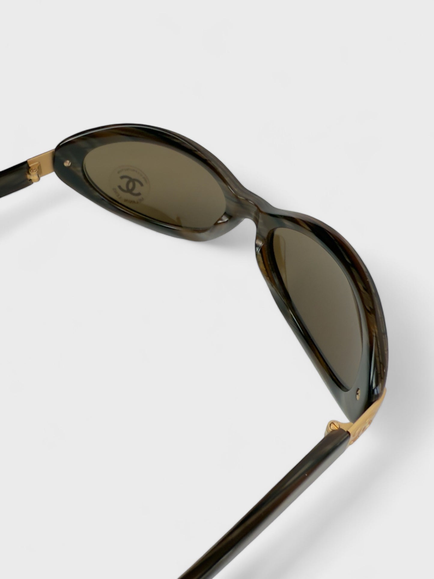 Chanel vintage 5027 sunglasses with oval frame and gold-tone details.