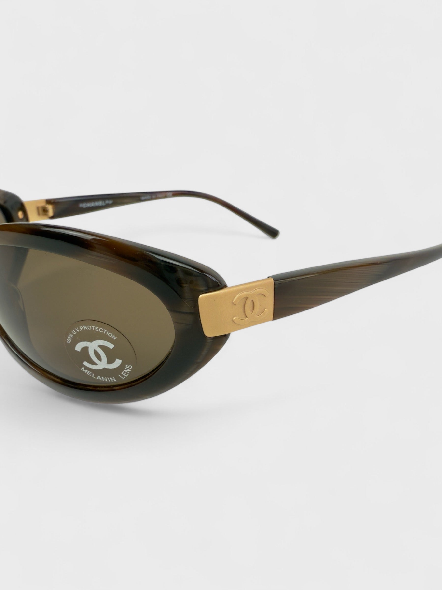 Chanel vintage 5027 sunglasses with oval frame and gold-tone details.