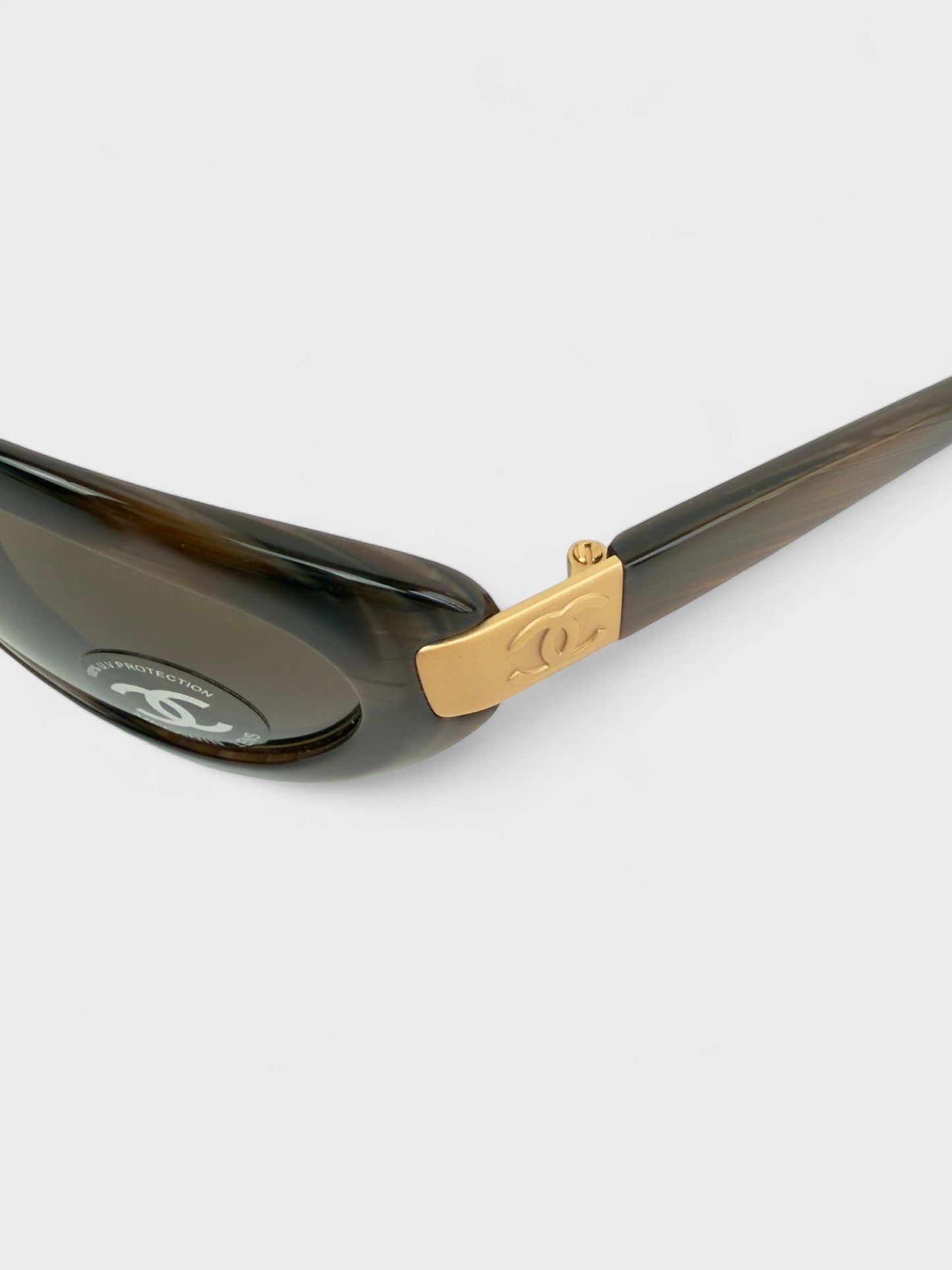 Chanel vintage 5027 sunglasses with oval frame and gold-tone details.