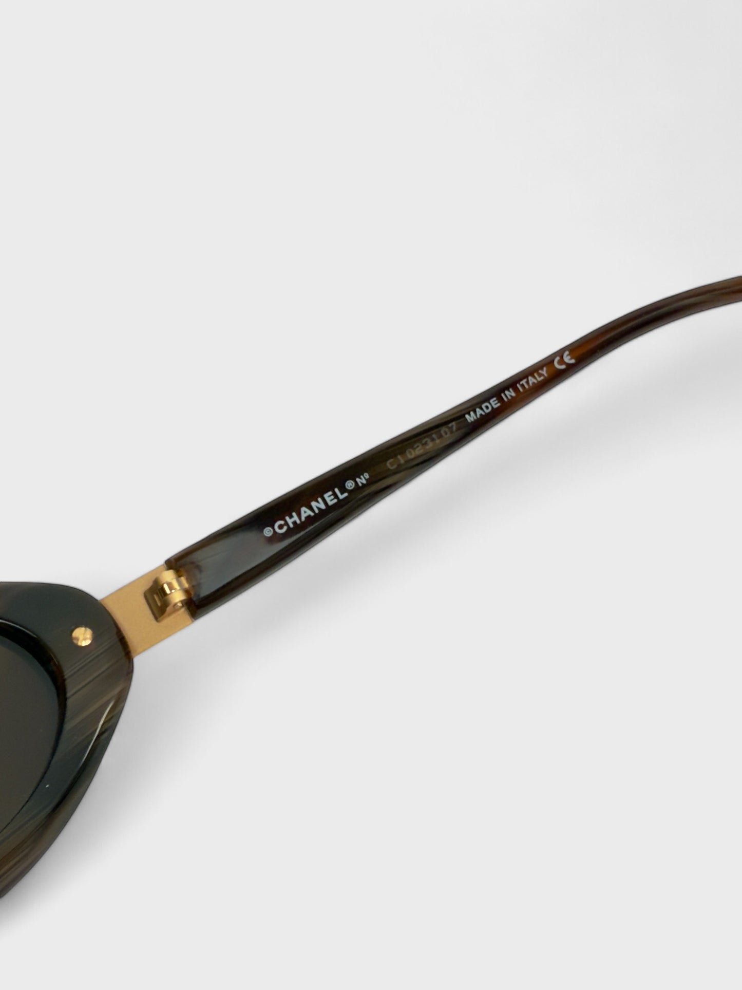 Chanel vintage 5027 sunglasses with oval frame and gold-tone details.