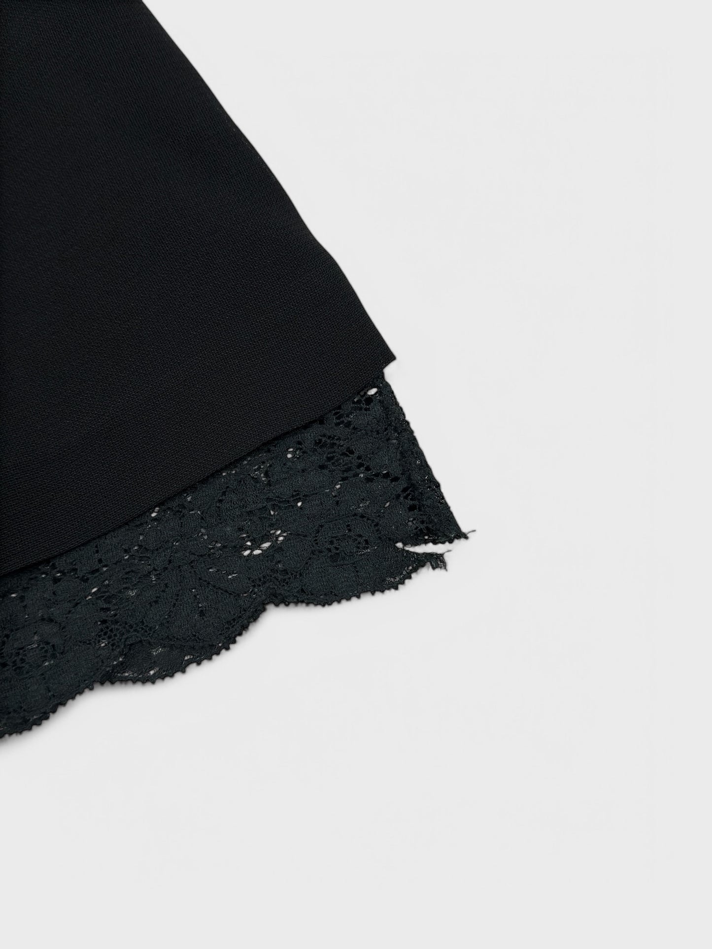 Dolce & Gabbana early 1990s black lace mini skirt with exposed trim.