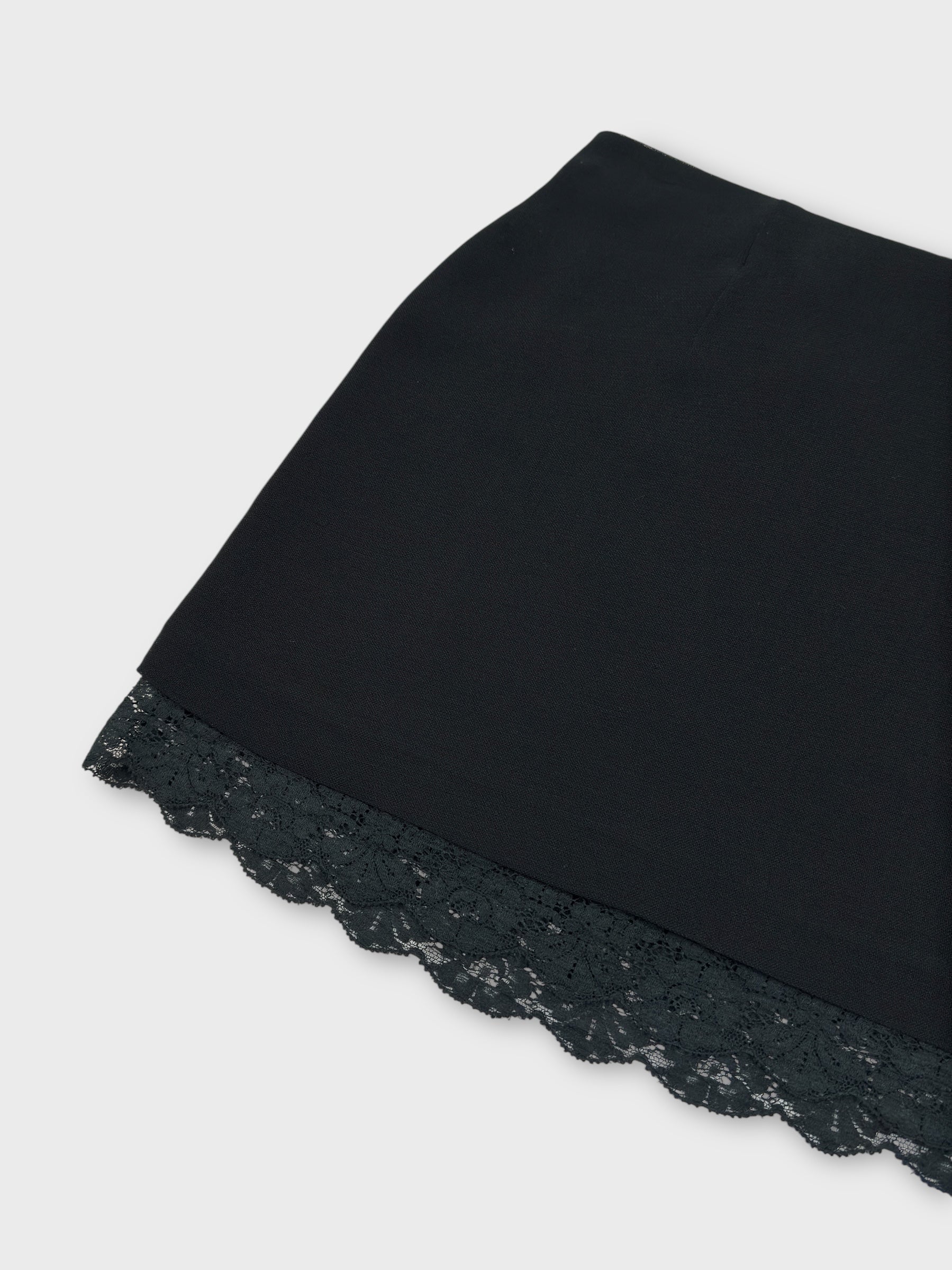 Dolce & Gabbana early 1990s black lace mini skirt with exposed trim.