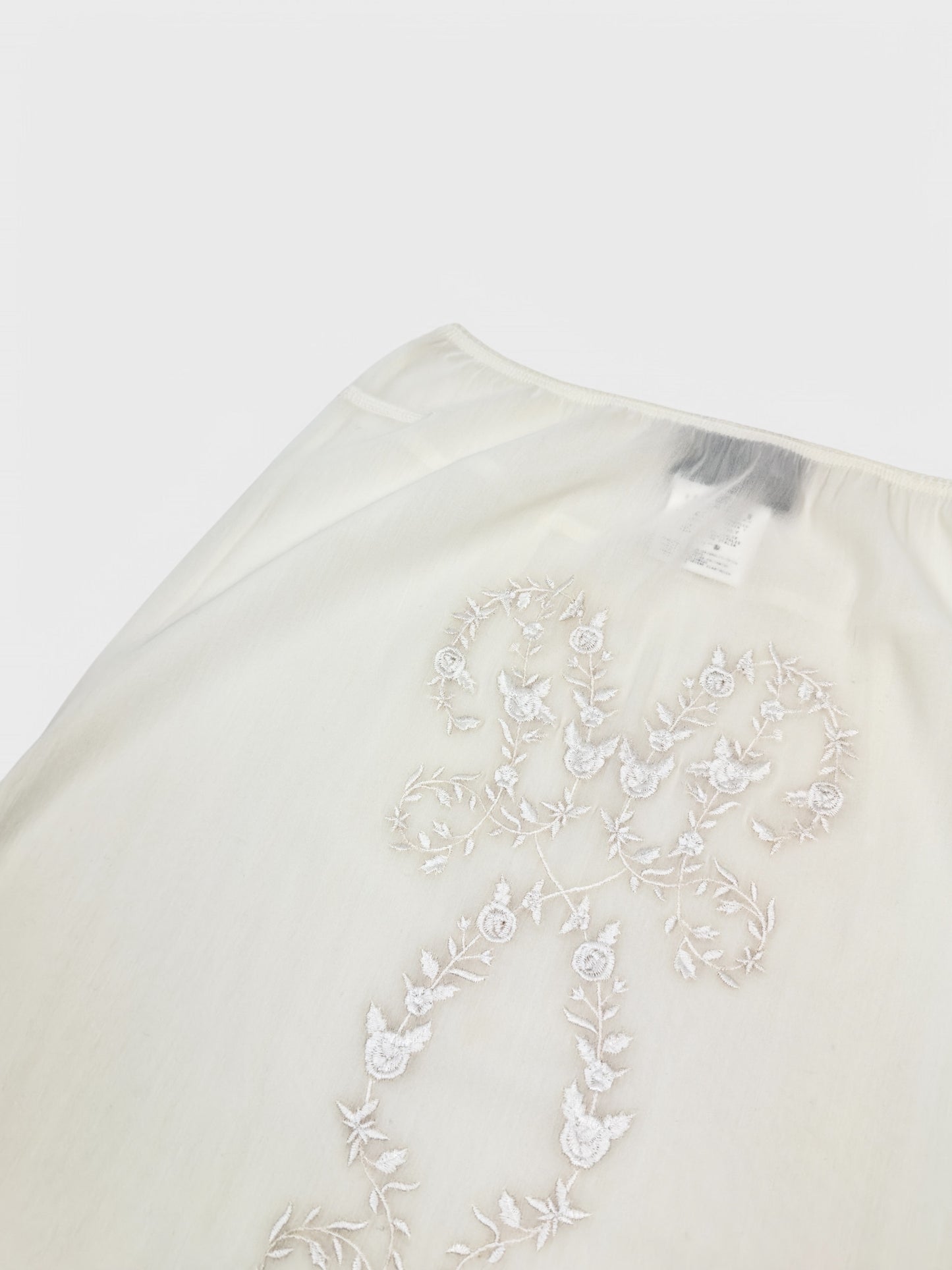 Dolce & Gabbana SS 1999 embroidered ivory pencil skirt with lace detailing and semi-transparent fabric.